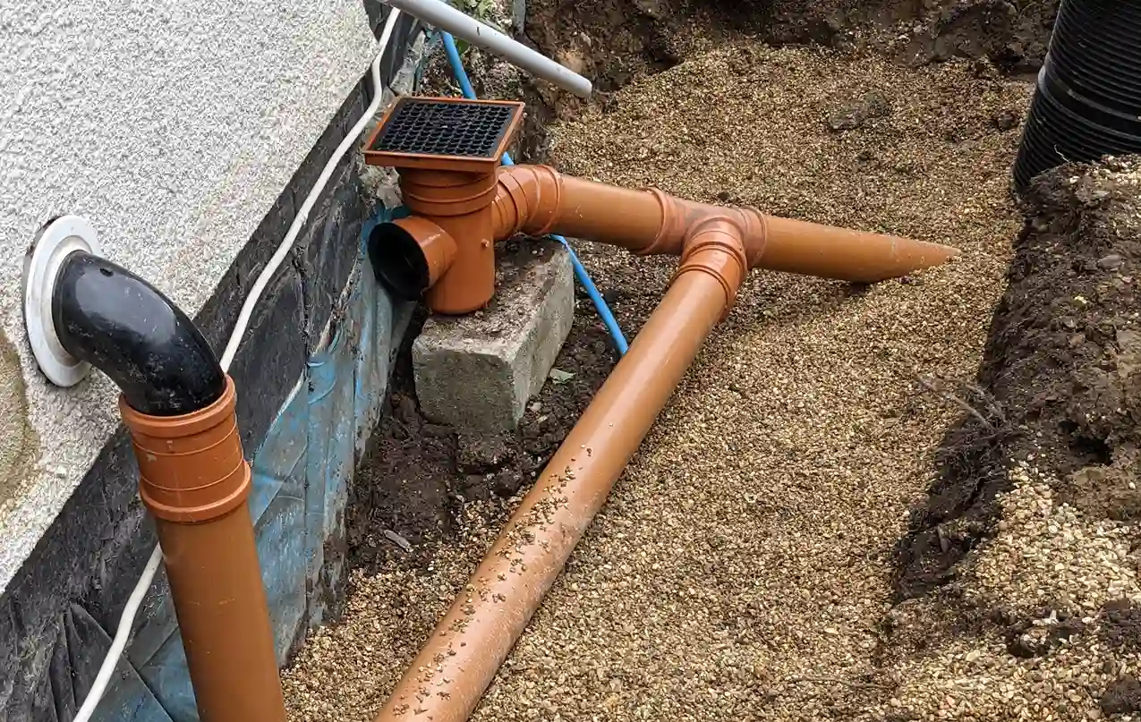 drainage surrounded by shingle